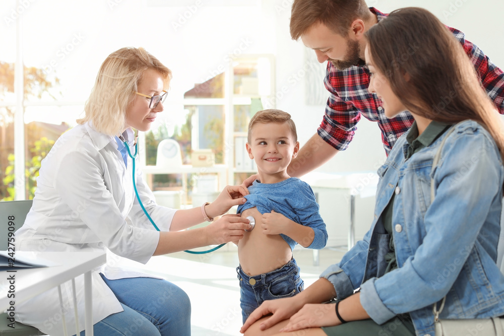 Children's doctor examining little boy with stethoscope in hospital Children's doctor examining little boy with stethoscope in hospital