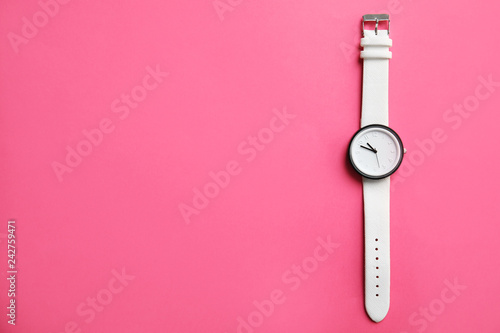 Stylish wrist watch on color background, top view with space for text. Fashion accessory photo