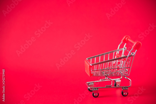 mini shopping cart on red background