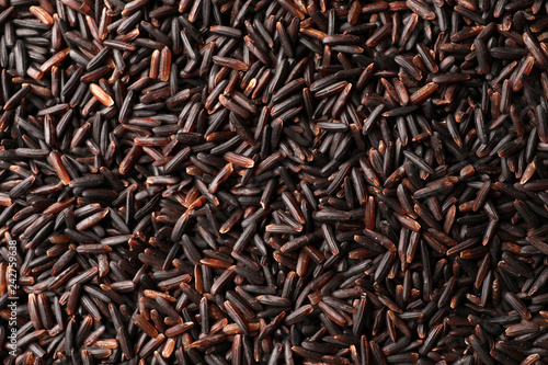 Raw brown rice as background, top view