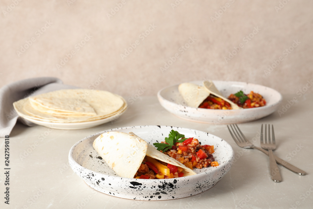 Chili con carne served with tortilla on table