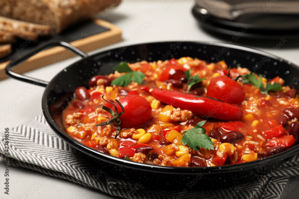 Dish with chili con carne on table Dish with chili con carne on table