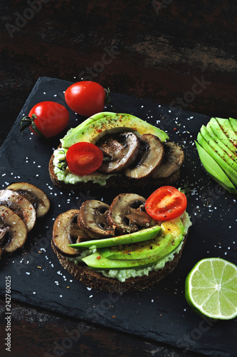 Beautifully served appetizing avocado toasts with mushrooms.