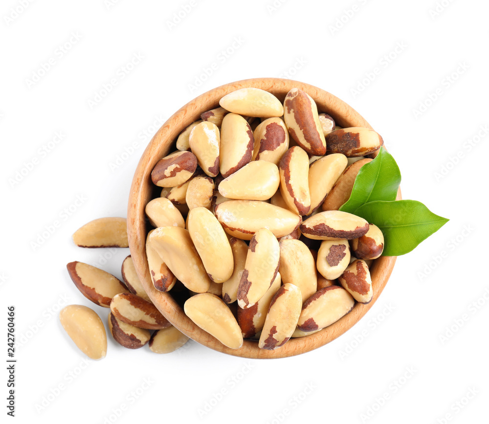 Brazil nuts in wooden bowl on white background, top view Brazil nuts in wooden bowl on white background, top view