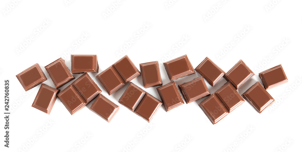 Pieces of tasty milk chocolate on white background, top view Pieces of tasty milk chocolate on white background, top view