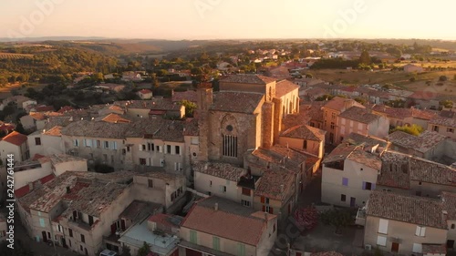 Aerial footage of flying around an 11th century old french provence church during sunset in Valensole photo