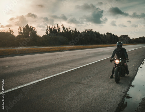 man riding bike on country road © Robert