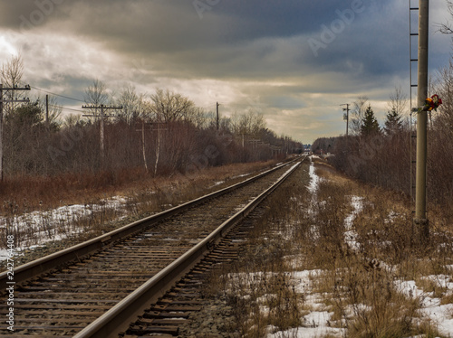 railway in winter under a moody sky, no people, empty, cold, snow.