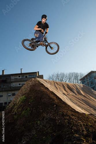 BMX Bike jump over a dirt trail