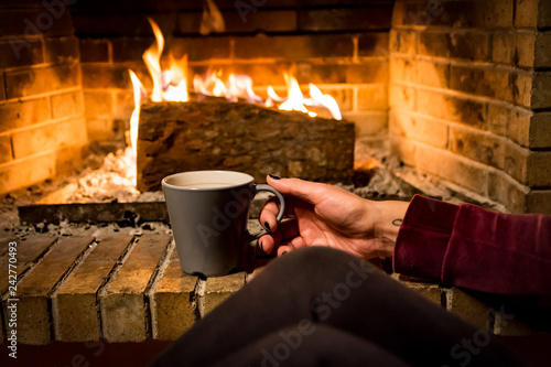 woman is warming in a fireplace