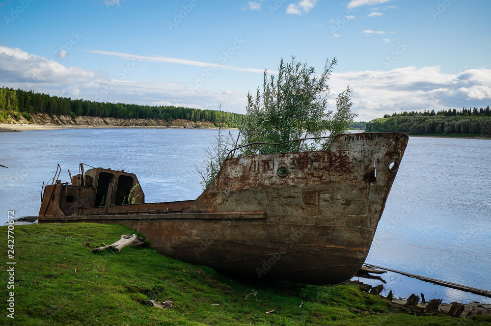 Abandoned ship on the river Bank Abandoned ship on the river Bank