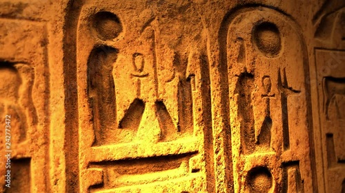 Ancient Egyptian Symbol of ten commandments or another object of ancient origin lit by candle