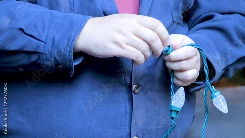 testing lightbulbs on a holiday strand of lights