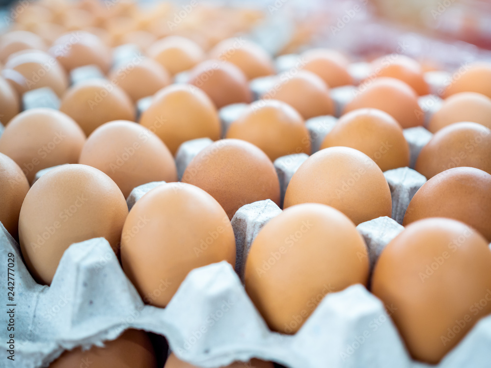 Close-up view of raw chicken eggs in egg box. Close-up view of raw chicken eggs in egg box.