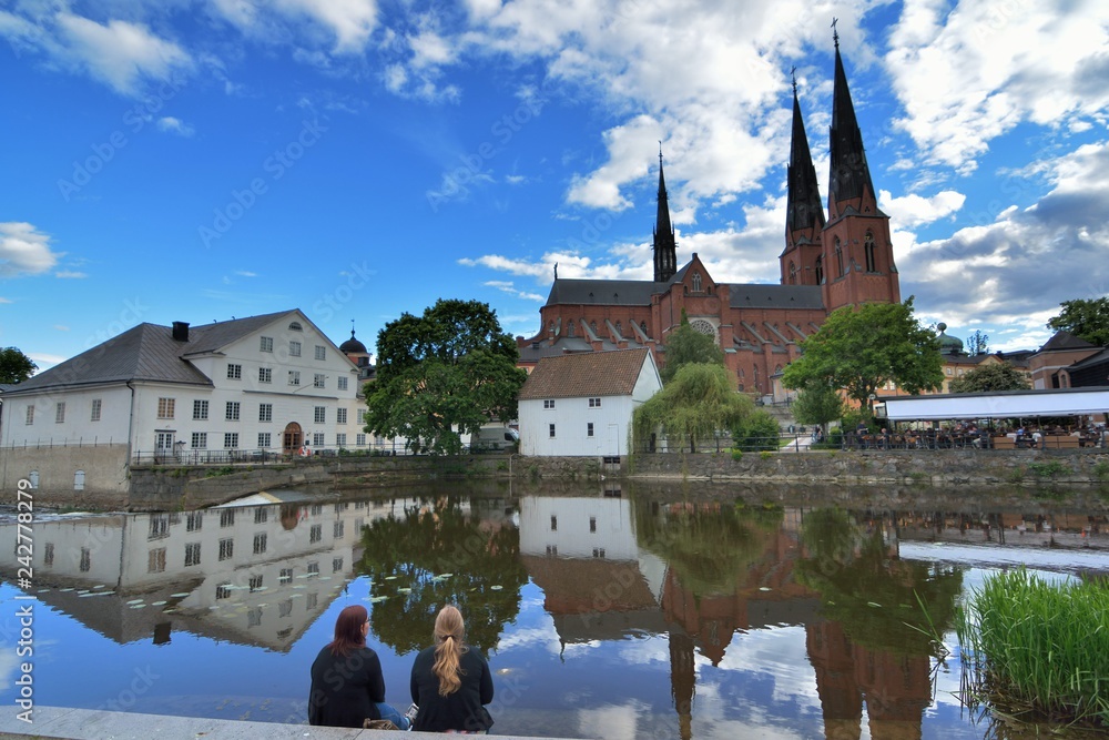 Fototapeta premium Uppsala University City, Sweden: Character Uppsala College Student. View the majestic Uppsala Cathedral, reflecting the beauty of Uppsala, Sweden. Travel time: May 31 to June 9, 2015; photo taken on: 