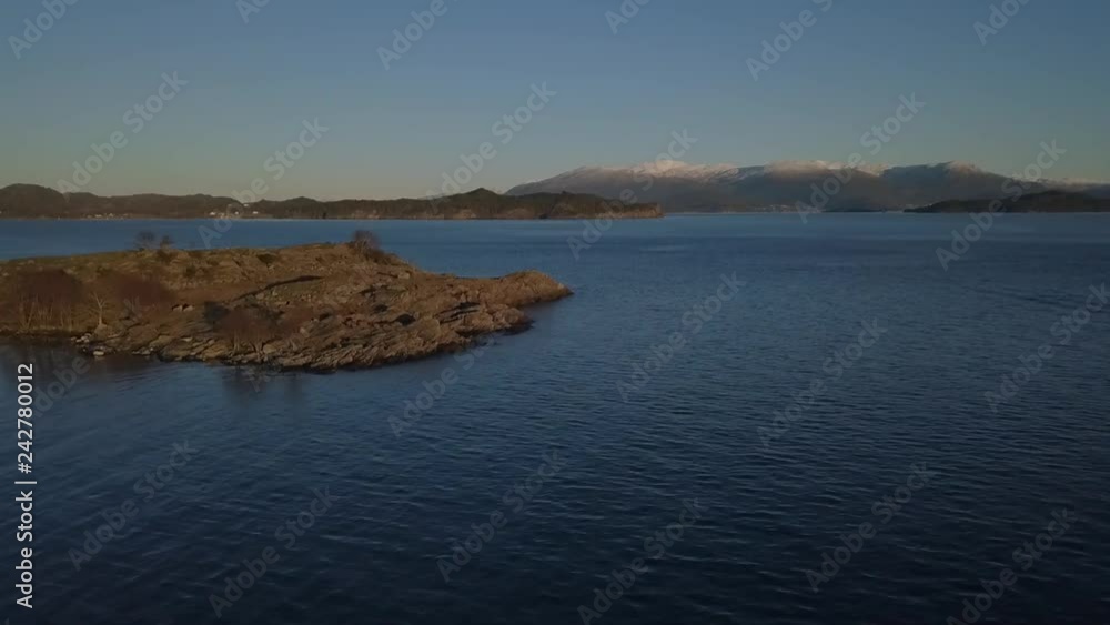 Drone shot flying over Norwegian fjord. Gaining altitude fast over the island. Drone shot flying over Norwegian fjord. Gaining altitude fast over the island.