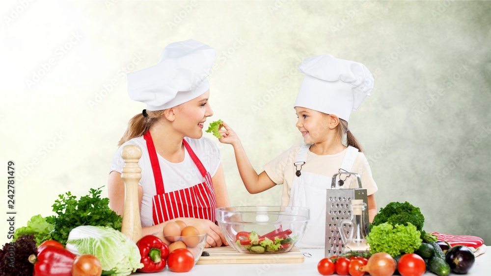Cute little girl with vegetables in kitchen Cute little girl with vegetables in kitchen