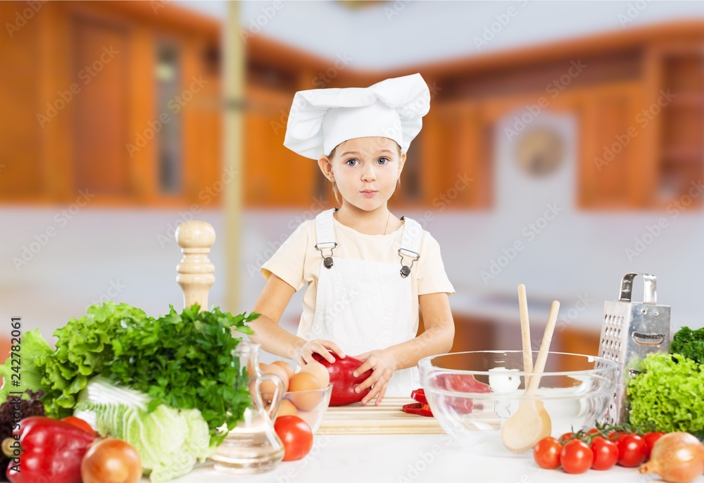 Cute little girl with vegetables in kitchen Cute little girl with vegetables in kitchen