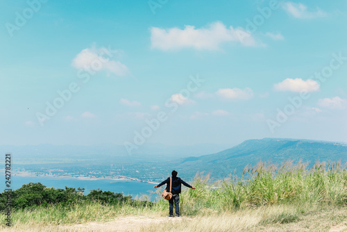 Happy man with hands up on Natural and sky background.