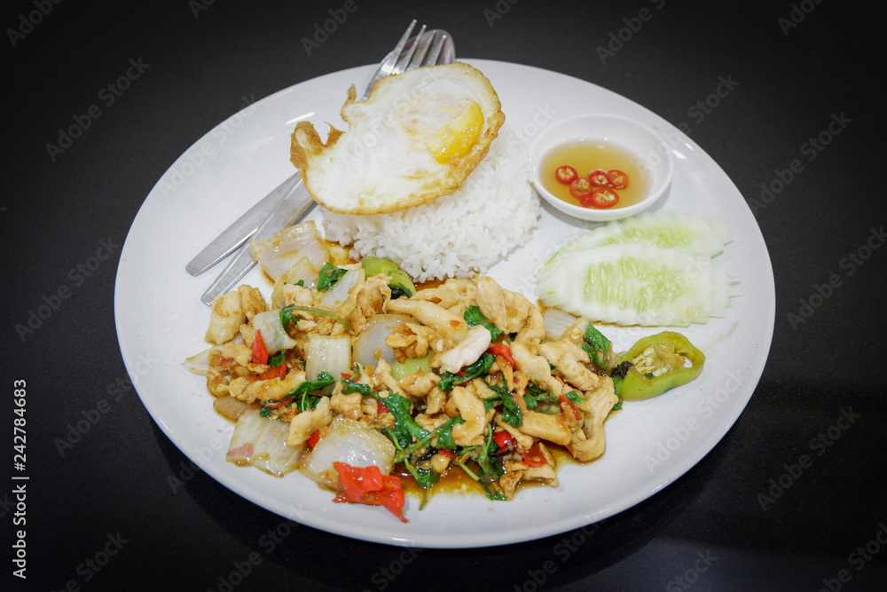 fried hot and spicy thai food stir fried holy basil chicken slice with fry an egg and cooking rice on plate fried hot and spicy thai food stir fried holy basil chicken slice with fry an egg and cooking rice on plate