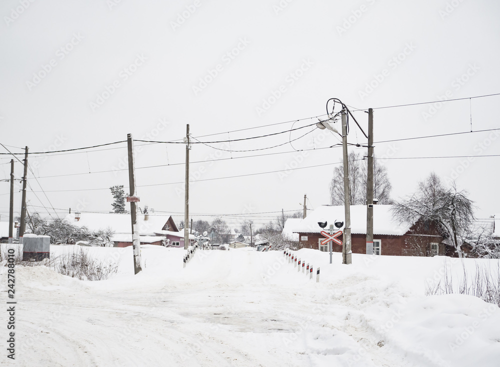 Snow-covered railway crossing in the village. Snow-covered railway crossing in the village.