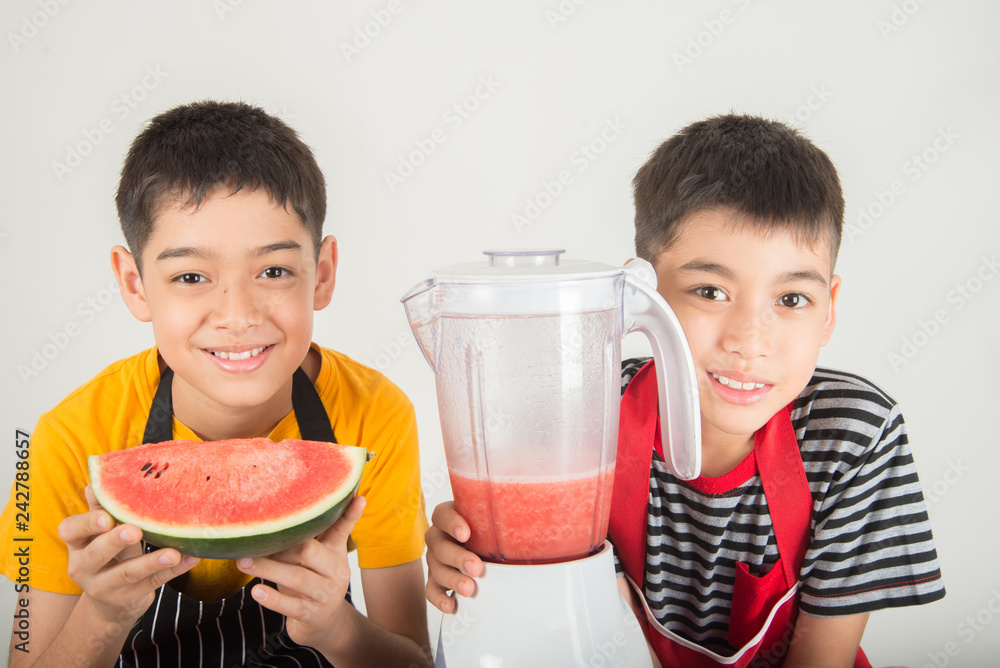 Little boys blend water melone juice by using blender at home Little boys blend water melone juice by using blender at home