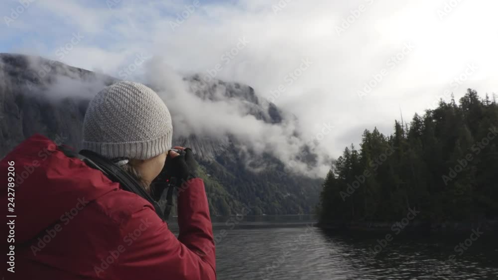 Alaska tourist photographer enjoying travel vacation cruise in Misty Fiords National Monument (aka Misty Fjords) taking pictures photographing the travel adventure in Alaska. Alaska tourist photographer enjoying travel vacation cruise in Misty Fiords National Monument (aka Misty Fjords) taking pictures photographing the travel adventure in Alaska.