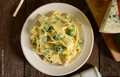 Tagliatelle pasta with cheese sauce and broccoli