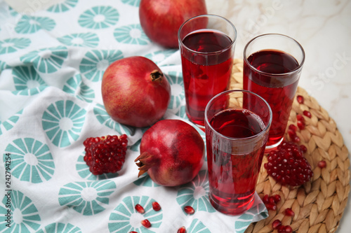 Glasses of pomegranate juice on table