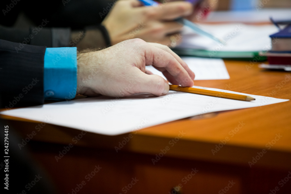 Close-up of business people writing text during business training Close-up of business people writing text during business training