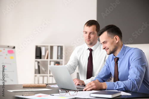 Young colleagues working together in modern office