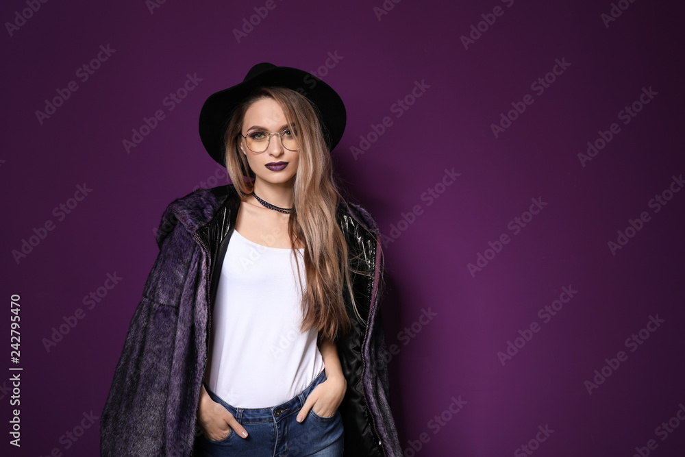 Fashionable young woman on violet background Fashionable young woman on violet background