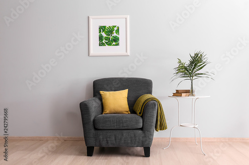 Interior of light room with comfortable armchair
