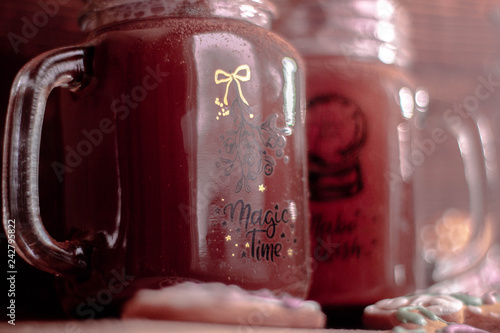 Mugs with chocolate and sweet marshmallow  on a wood desk with different lights