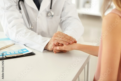 Male doctor calming female ...