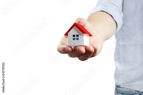 Hand holding a small house, isolated on white background