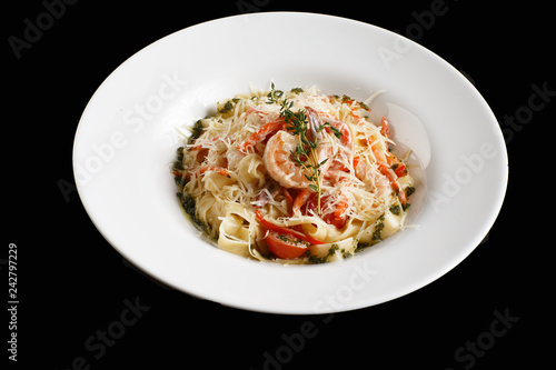 pasta in cream sauce with king prawns on a plate