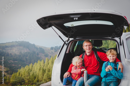 happy father with kids travel by car in nature