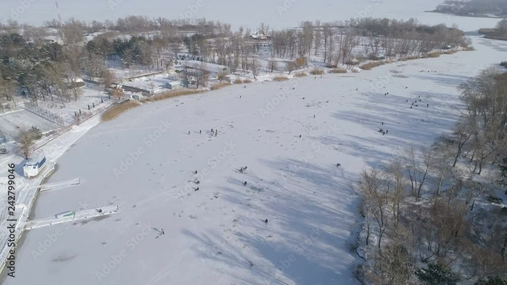 Aerial View Of River, Fishermen on Ice. Sunny Winter Day. Energodar, Ukraine. 4K video
Aerial View Of River, Fishermen on Ice. Sunny Winter Day. Energodar, Ukraine. 4K video