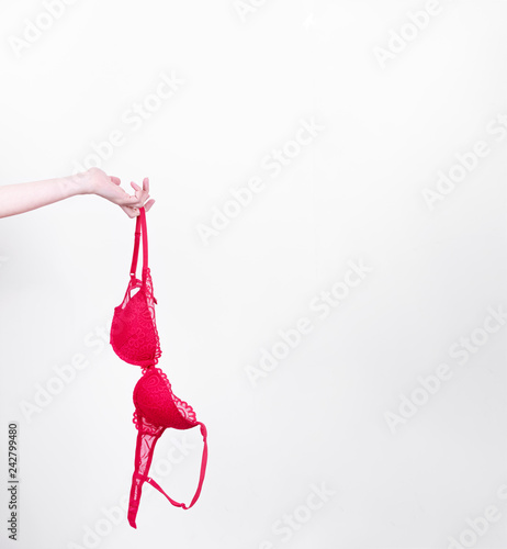 woman hand holds red lingerie in her hand