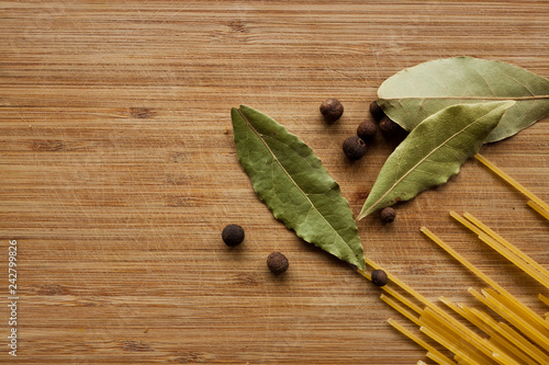Fototapeta Naklejka Na Ścianę i Meble -  Spices on wood background. Pepper, Bay leaf, Basil