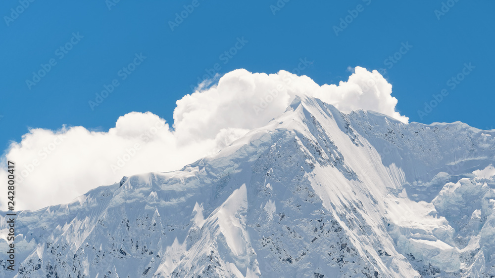Closeup of Midui Glacier, the most beautiful glacier in China, snow mountain landscape with blue sky background.