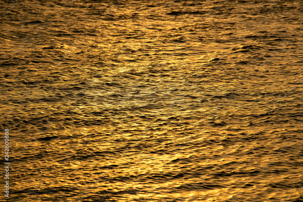 Sunset reflection sparkles on tiny ripples of sea water wave Sunset reflection sparkles on tiny ripples of sea water wave