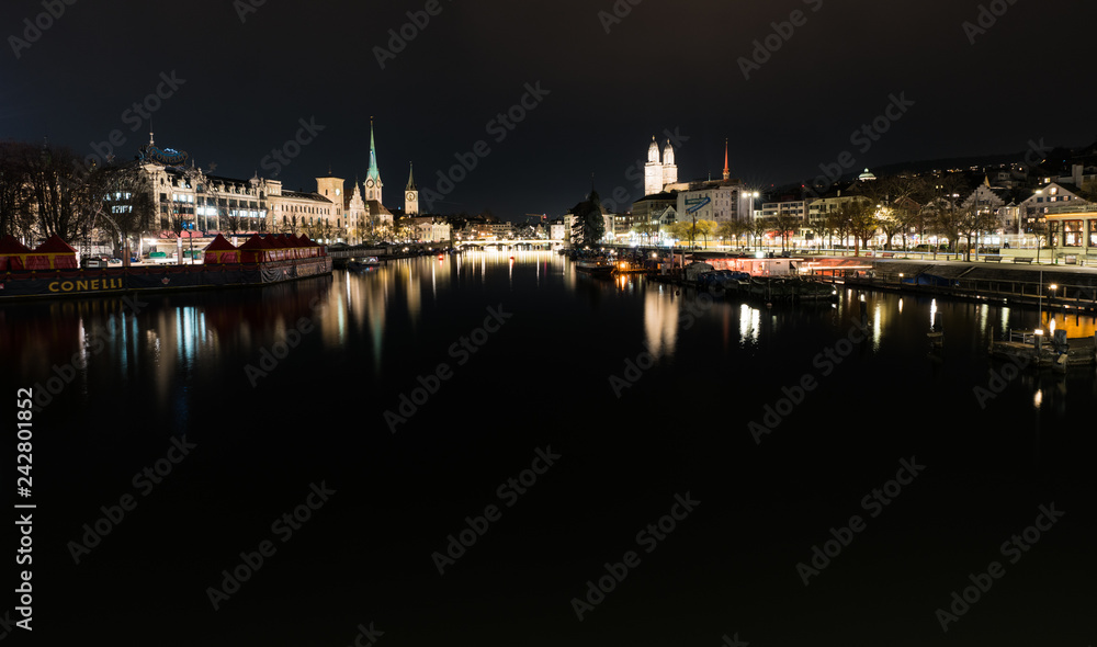Zurich, ZH / Switzerland - January 4, 2019: night time city skyline view of Zurich with the river Limmat