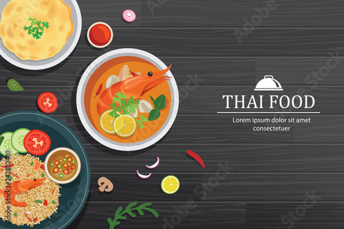 Tom yum kung in the bowl on black wood table top view. Thailand set food background.