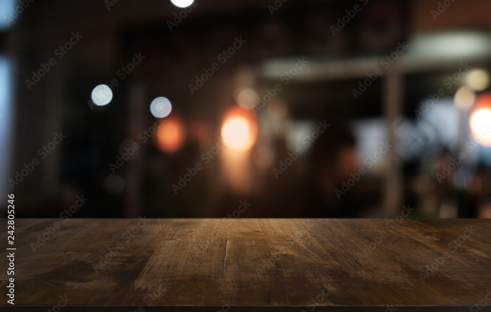 Empty dark wooden table in front of abstract blurred bokeh background of restaurant . can be used for display or montage your products.Mock up for space. Empty dark wooden table in front of abstract blurred bokeh background of restaurant . can be used for display or montage your products.Mock up for space.