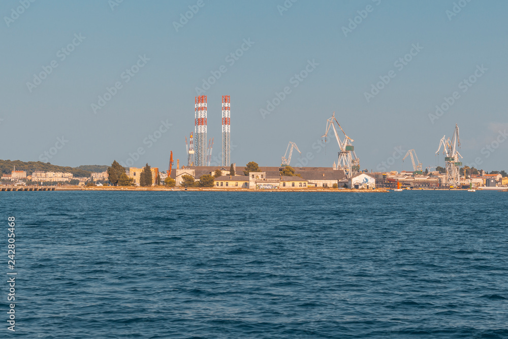 dockyard in Pula with cranes while loading a ship, industry