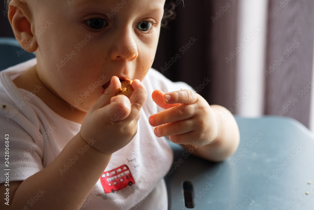 Feeding a baby in a highchair. Food Dirty Kid Feeding a baby in a highchair. Food Dirty Kid