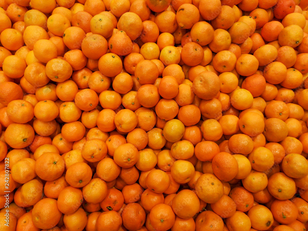 Ripe tangerines in a store window