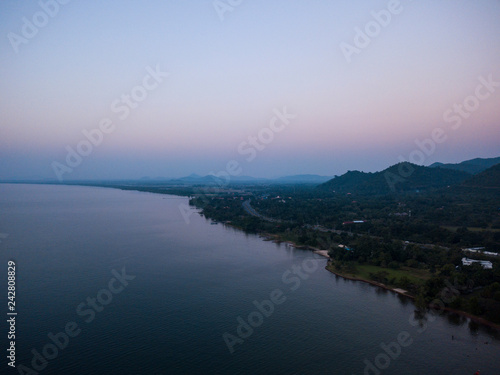 Aerial view of sea and beach with coconut palm tree on island at sunset time
